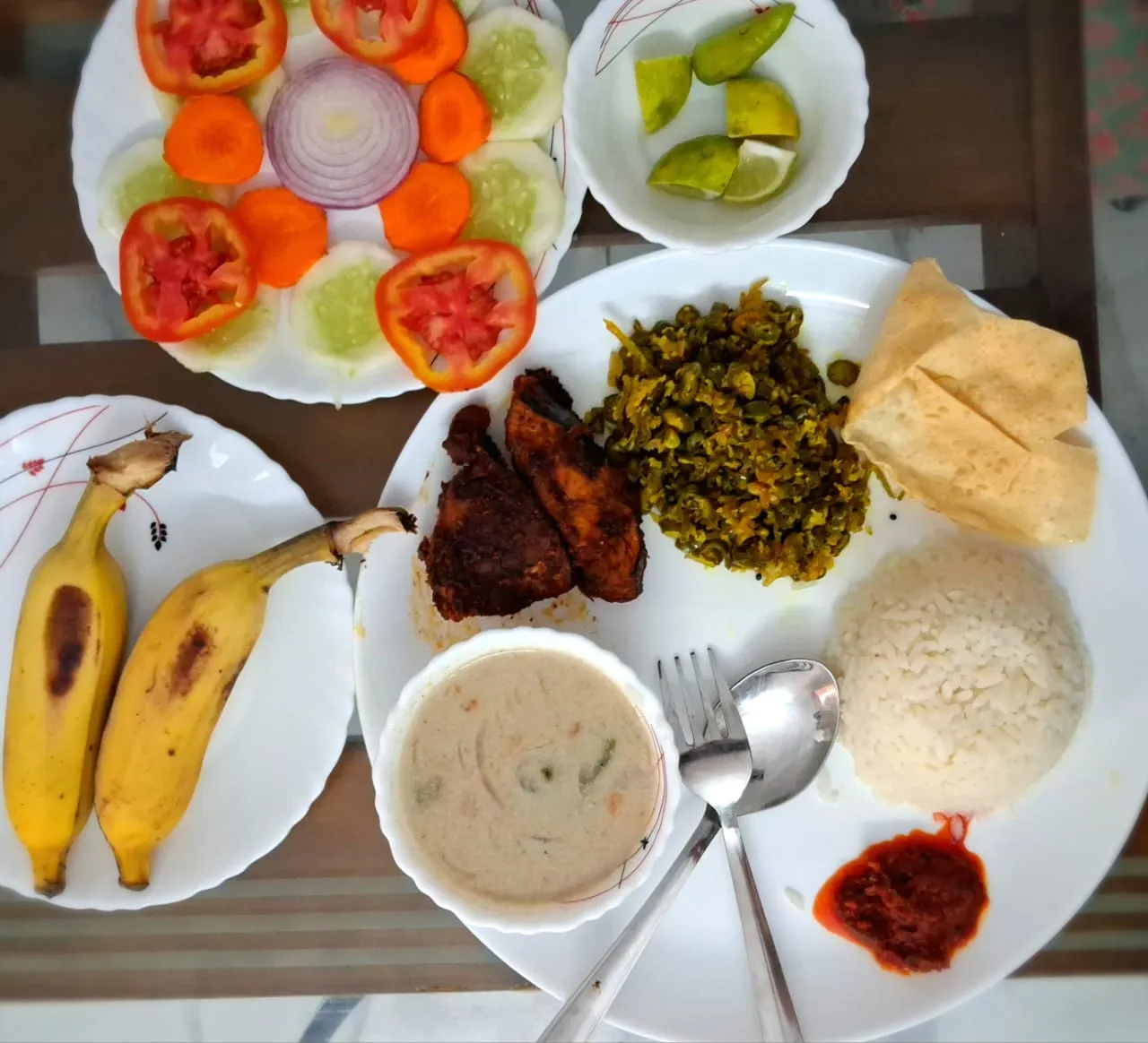 Home-cooked lunch with fish, rice and fruit