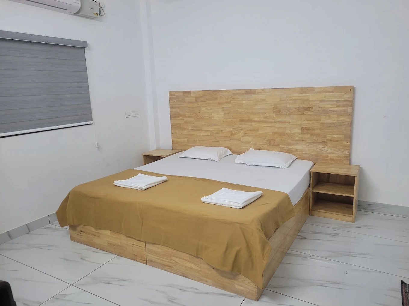 Double room with wooden headboard and fresh towels